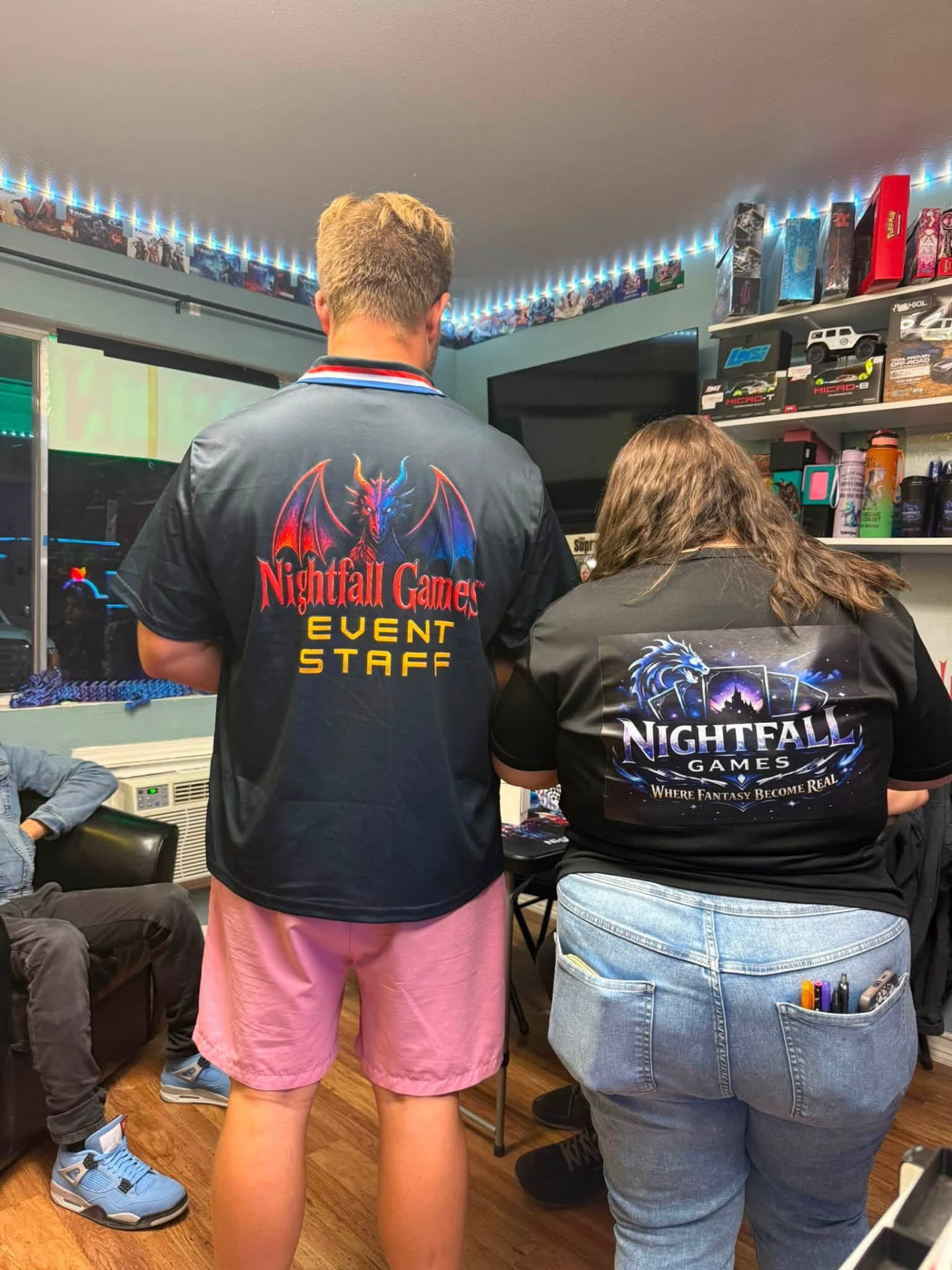 Nightfall Games™ event staff wearing branded dragon jerseys while running an event in the Pahrump store