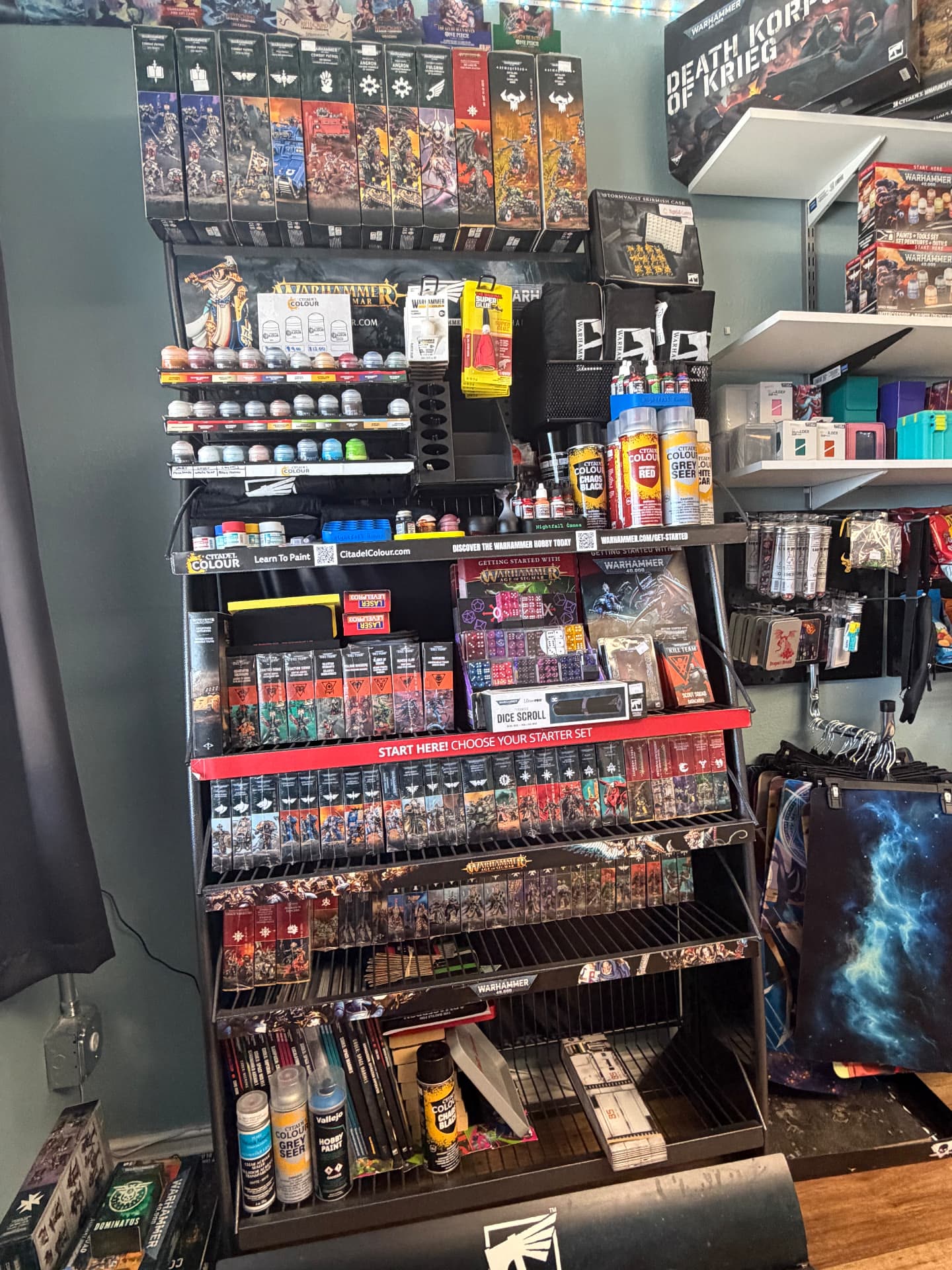 Warhammer hobby tower at Nightfall Games™ with Citadel paints and sprays, Kill Team boxes, Combat Patrol sets and Age of Sigmar miniatures